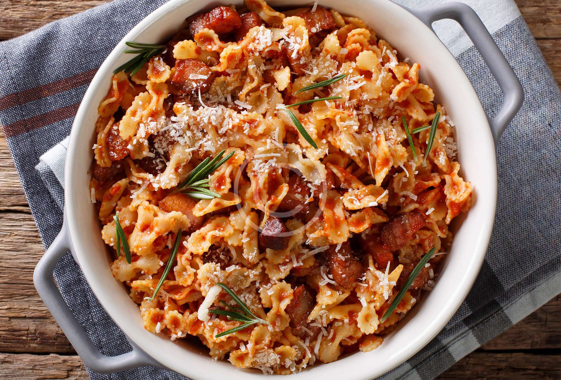 Baked pasta with tomato,  bacon & cheese